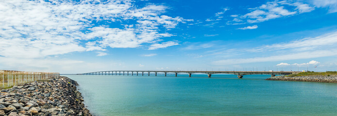 Panoramic view of the Ile de Ré bridge seen from La Rochelle shore on a sunny day in Charente-Maritime, France