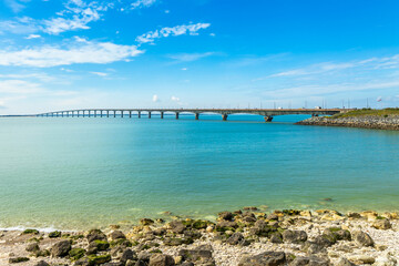 Ile de Ré bridge seen from La Rochelle seashore on a sunny day in Charente-Maritime, France
