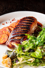 Roasted Duck breast fillets with vegetable salad and batat in plate