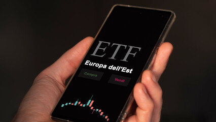 An Italian investor analyzing an etf fund on a phone. Italian text: Eastern Europe, buy, sell.