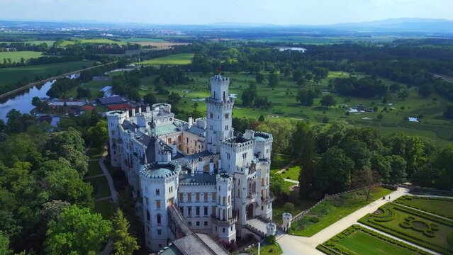 white Fairy tale Castle in Czech Republic. Amazing aerial top view flight drone