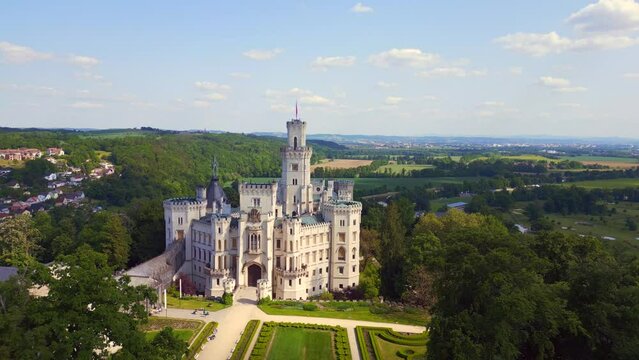 white Fairy tale Castle in Czech Republic. Stunning aerial top view flight drone