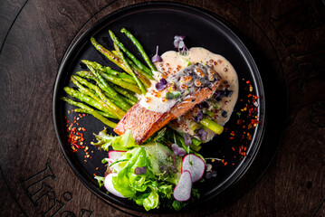 salmon steak with asparagus and salad