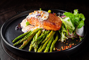 salmon steak with asparagus and salad