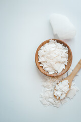 Soy wax on a wooden spoon. Natural, ecological, renewable, vegan. Soy candle wax