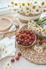 Summer composition, plate with strawberries and chamomile