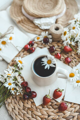 Vintage still life on the windowsill, a cup of tea and a bouquet of daisies