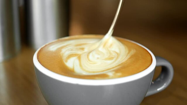 Stirring thick foam cappuccino with spoon. Milk foam cappuccino, latte