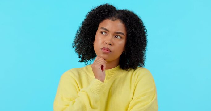 Thinking, idea and confused with face of woman on studio for solution, doubt and problem solving. Question, vision and mindset with person on blue background for planning, decision and brainstorming