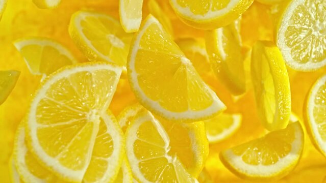 Super slow motion of flying lemon slices on black background. Filmed on high speed cinema camera, 1000 fps. Camera placed on high speed cine bot, tracking the object. Speed ramp effect.