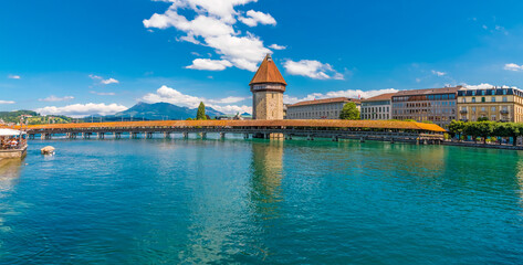 Picturesque panorama photo of the famous diagonal wooden covered footbridge, the Kapellbrücke...