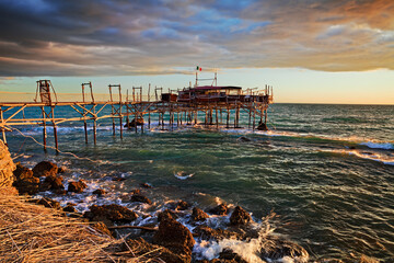 Rocca San Giovanni, Chieti, Abruzzo, Italy: landscape of the Adriatic sea coast at dawn with an ancient fishing hut trabocco, the typical Mediterranean wooden pilework - 615839635