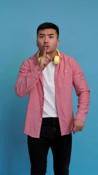 Man making a silent gesture with his finger. Vertical video.