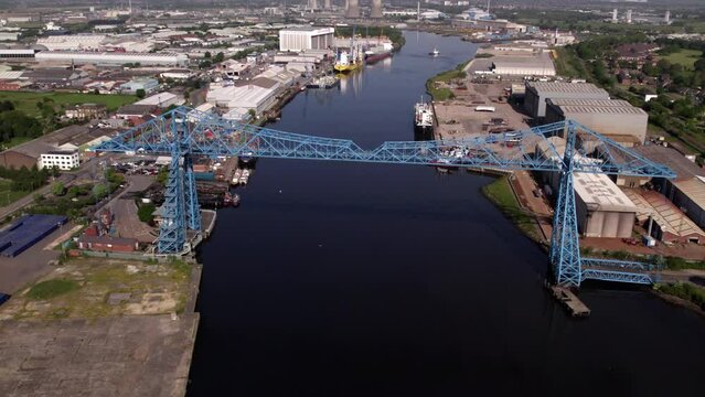 Drone flies slowly back from Transporter Bridge at height. Shot on a sunny spring morning in Middlesbrough 