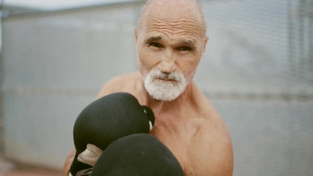 80 years old man making sport and different activities outdoor. Senior man training in the city. Concept about healthy lifestyle and seniority