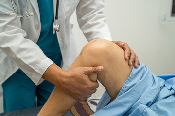 Asian elderly woman patient show her scars surgical total knee joint replacement Suture wound...