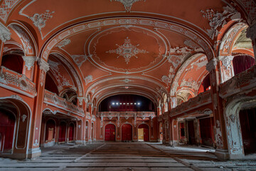 Fototapeta premium Exploring the Historic Abandoned Red Cinema and Abandoned Red Theatre in Miskolc, HungaryJourney Through Time and Culture
