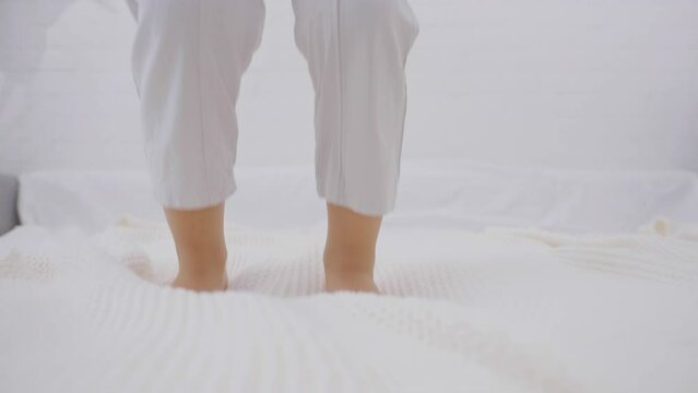 Active kid jumping on the bed