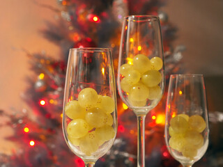 New Year Celebration with Wine Glasses and Twelve Grapes