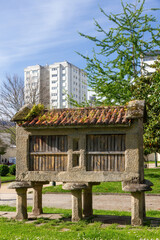 Fototapeta na wymiar Typical Galician granary horreo in a park, Construction of popular architecture to store grain and other field products, Raised from the ground to avoid humidity and rodents, Pontevedra, Galicia