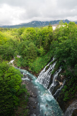 Naklejka na ściany i meble Shirahige Falls, Biei, Hokkaido, Japan, waterfall flowing off the mountain
