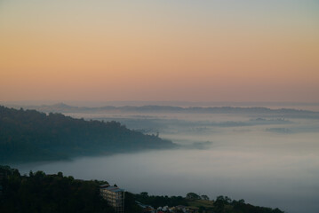 sunrise over the mountains with thick fog