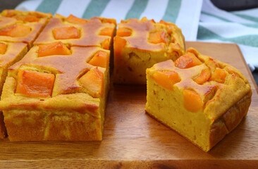 Delectable Freshly Baked Homemade Pumpkin Cake on Wooden Breadboard
