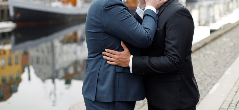 Gay Couple Wearing Black And Blue Suits Having A Wedding, Same Sex Couple Marriage.