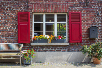Fototapeta na wymiar Old German house with window with wooden shutters, Wachtendonk