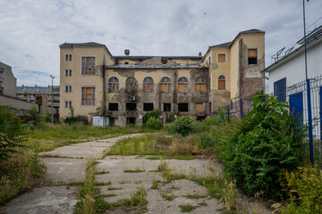 Fototapeta premium Exploring the Historic Abandoned Red Cinema and Abandoned Red Theatre in Miskolc, HungaryJourney Through Time and Culture