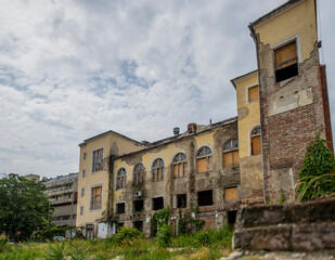 Fototapeta premium Exploring the Historic Abandoned Red Cinema and Abandoned Red Theatre in Miskolc, HungaryJourney Through Time and Culture