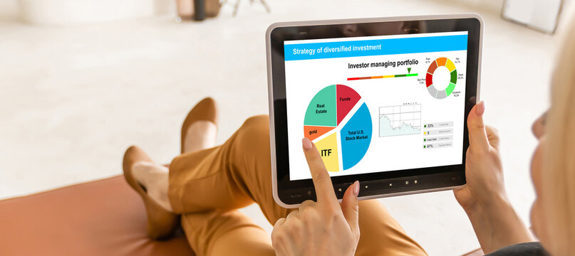 Strategy of diversified investment. Investor managing portfolio. Pie chart and candlestick charts. 