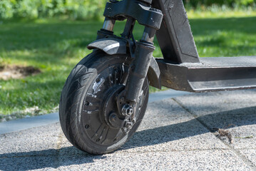 Details mechanism of used electric scooter closeup. Wheel, shock absorber public mobile transport....