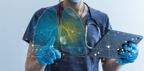 Close up of female doctor holding tablet with abstract glowing lung interface with virus outline on dark background. Medicine, pandemic and healthcare concept. Double exposure