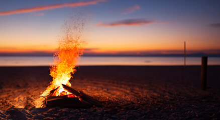beautiful campfire in the middle of a beautiful beach in summer with a sunset in the background HD
