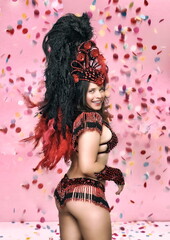 beautiful model in brazilian carnival costume dancing in studio