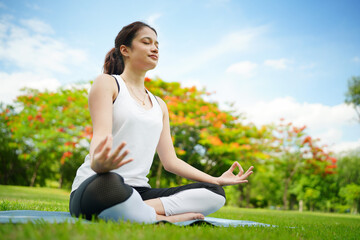 Fototapeta na wymiar Pleasant millennial woman practice yoga outdoor in the morning during wellness retreat.