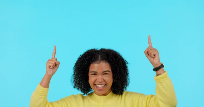 Presentation, woman pointing up for promotion and against a blue background with a smile. Announcement or marketing, mockup space or giveaway and female person point for advertising information
