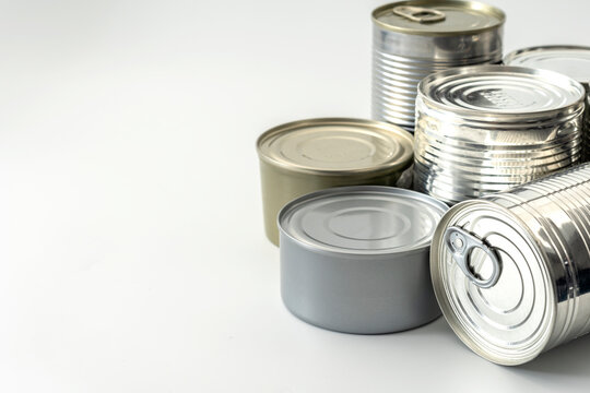 Shiny Metal Cans on White Background With Copy Space Concept for Old-fashioned Food Storage, Sustainable Recyclable Packaging, and Meal Preparation for Emergencies