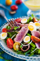 Tuna salad ( Nicoise) with tomatoes, boiled eggs, onion, anchovy and lettuce