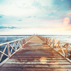 Obraz premium Pier on the sea at sunset. Freedom and relax concept