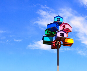 Colorful nesting boxes on blue sky background
