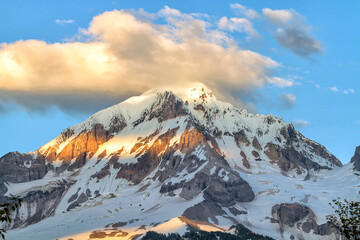 Fototapeta na wymiar Mount Hood and clouds over mountain top peak during summer closeup