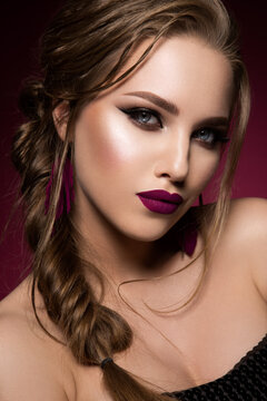 Glamour portrait of beautiful girl model with makeup and romantic hairstyle. Fashion shiny highlighter on skin, sexy gloss lips make-up and dark eyebrows. Pink lips