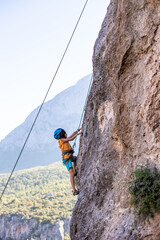 climber boy. the child trains in rock climbing.