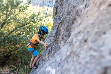 climber boy. the child trains in rock climbing.