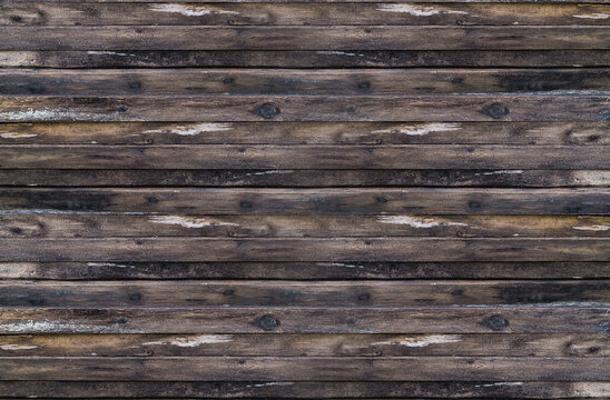 Background stacked stack of dark brown weathered boards