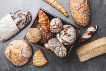 A basket full of delicious freshly baked bread on wooden background