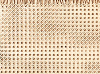 Embossed background of large-weave rattan stems close-up - obrazy, fototapety, plakaty
