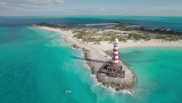 Flying Towards a Red White Lighthouse on a Small Carribean Island Surrounded by Blue Waters